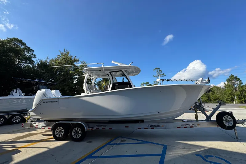 Slide: The Image of 2024 Sportsman Open 302 Center Console boat on trailer under clear blue sky. - 8