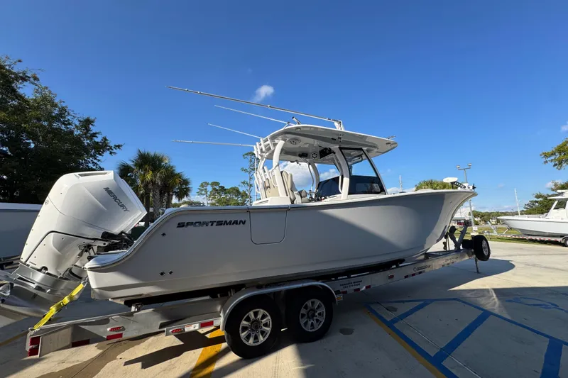 Slide: The Image of 2024 Sportsman Open 302 Center Console boat on trailer under clear blue sky. - 9