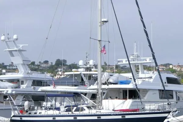 Slide: The Image of Luxurious 2006 Tayana 58 Deck Salon interior with elegant wood flooring and curved seating. - 1