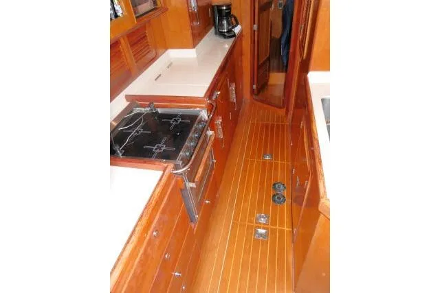 Slide: The Image of Luxurious galley in 2006 Tayana 58 Deck Salon yacht with stove, microwave, and bar area. - 11