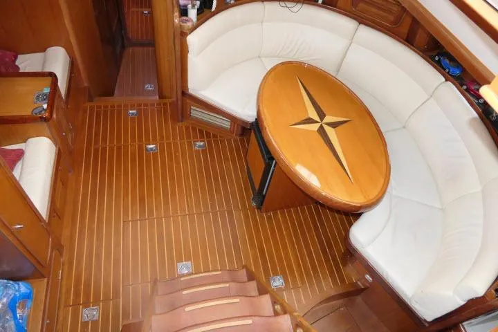 Slide: The Image of Luxurious 2006 Tayana 58 Deck Salon interior with elegant wood finish and comfortable seating. - 2