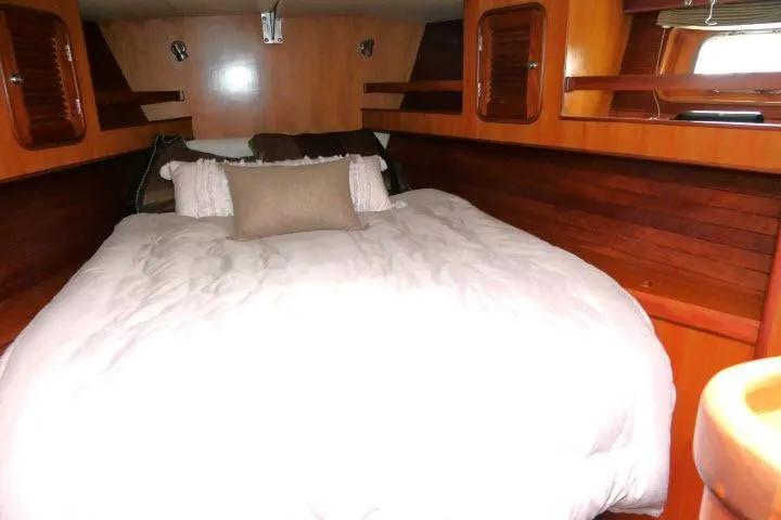 Slide: The Image of Cozy bedroom in 2006 Tayana 58 Deck Salon yacht with wooden interior and window. - 22