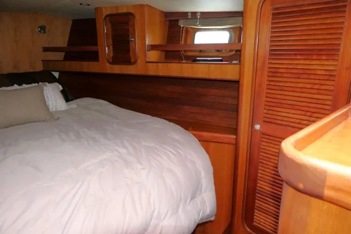 Slide: The Image of Interior of 2006 Tayana 58 Deck Salon with wooden cabinetry and louvered door. - 23