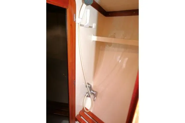 Slide: The Image of Luxurious 2006 Tayana 58 Deck Salon bedroom with nautical-themed bedding and wooden interior. - 28