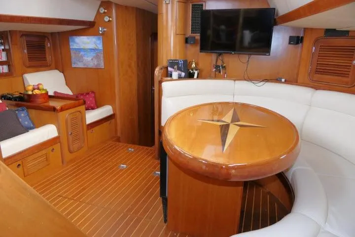 Slide: The Image of Luxurious 2006 Tayana 58 Deck Salon interior with wood finish and comfortable seating. - 3