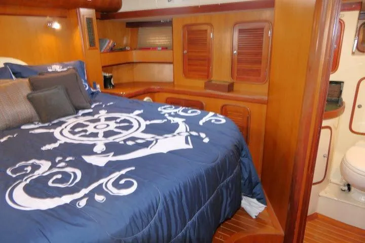 Slide: The Image of Luxurious 2006 Tayana 58 Deck Salon interior with nautical-themed bedding and modern amenities. - 32