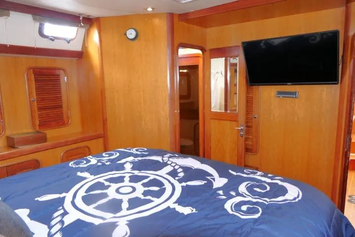 Slide: The Image of Interior of 2006 Tayana 58 Deck Salon with wood paneling and mounted TV. - 33