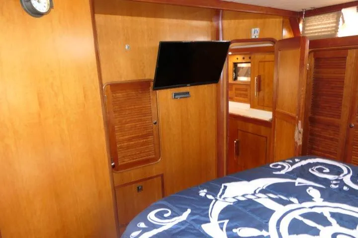 Slide: The Image of 2006 Tayana 58 Deck Salon yacht bathroom with toilet, sink, and mirror. - 34