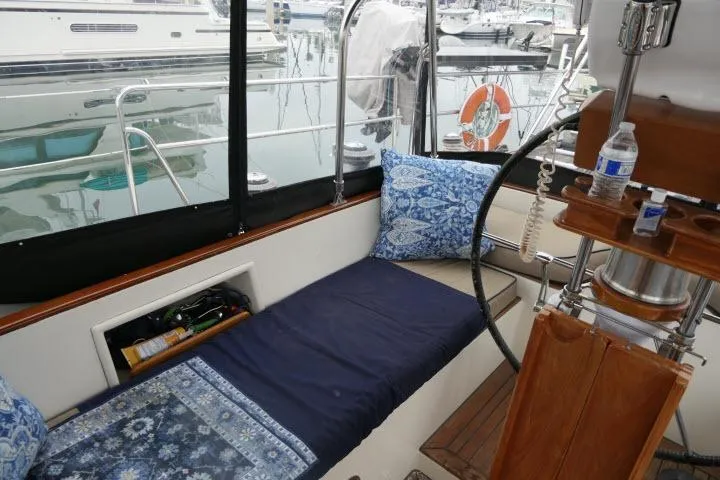 Slide: The Image of Cozy seating area on 2006 Tayana 58 Deck Salon yacht with blue cushions and wooden accents. - 38