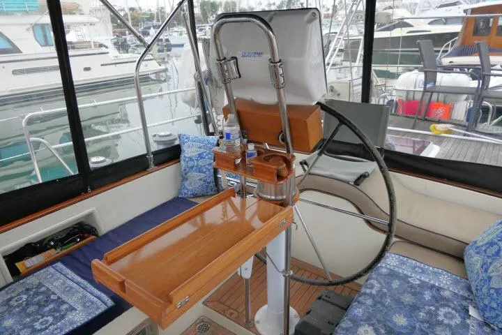 Slide: The Image of 2006 Tayana 58 Deck Salon cockpit with polished wood table and nautical seating. - 40