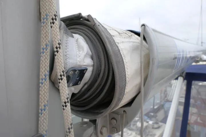 Slide: The Image of 2006 Tayana 58 Deck Salon yacht with wooden deck, docked alongside other boats. - 57