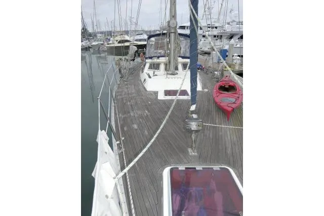 Slide: The Image of 2006 Tayana 58 Deck Salon yacht deck with hatch and winch in marina. - 58