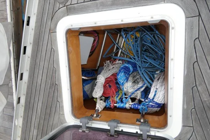 Slide: The Image of Bow view of 2006 Tayana 58 Deck Salon yacht with anchor chain and winch. - 60