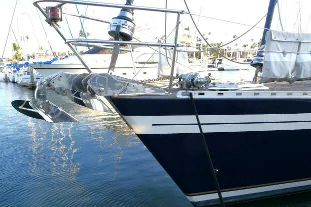 Slide: The Image of 2006 Tayana 58 Deck Salon yacht docked in a marina, surrounded by other boats. - 62