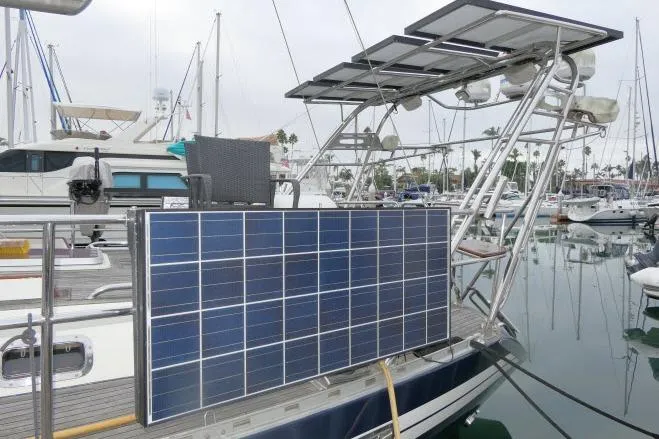 Slide: The Image of Polished wooden seat on 2006 Tayana 58 Deck Salon yacht, surrounded by stainless steel railings. - 67