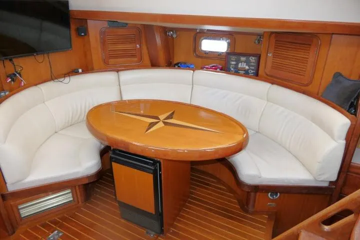Slide: The Image of Interior of 2006 Tayana 58 Deck Salon yacht, featuring a well-equipped galley kitchen. - 9