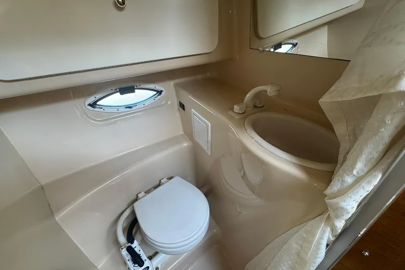 Slide: The Image of 2003 Maxum 2400 SCR cabin interior with kitchenette and seating area. - 20