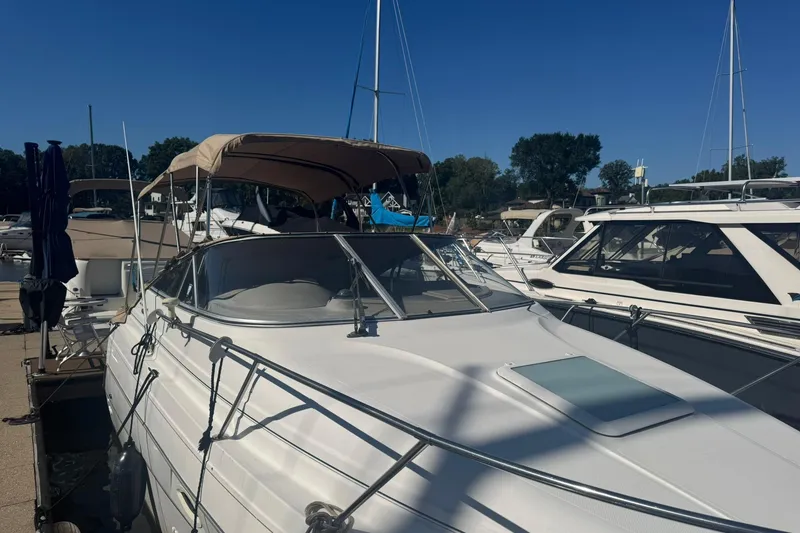 Slide: The Image of 2003 Maxum 2400 SCR boat docked at marina under clear blue sky. - 4