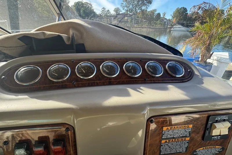 Slide: The Image of 2003 Maxum 2400 SCR boat interior with white seating and a small table. - 7