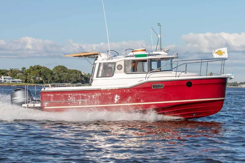 The Image of 2017 Ranger Tugs R-23 boat cruising on water, red hull, Yamaha engine, sunny day. - 0