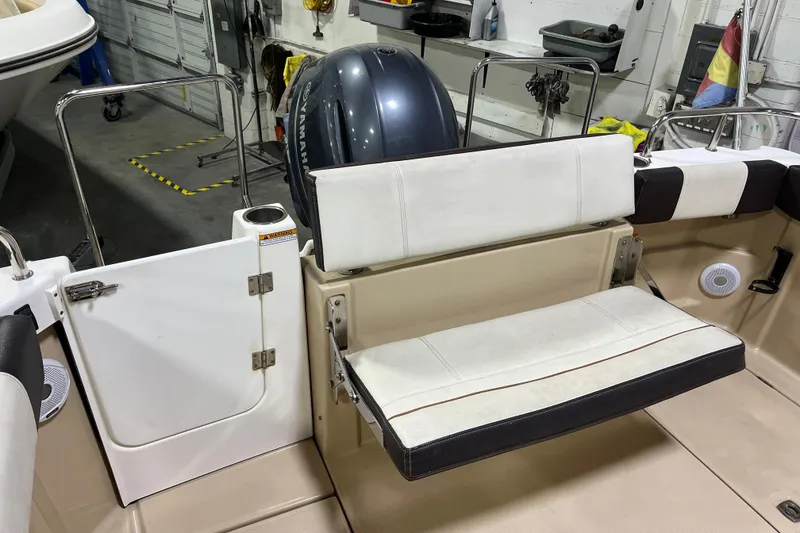Slide: The Image of 2017 Ranger Tugs R-23 boat interior with seating and Yamaha engine in a garage. - 10