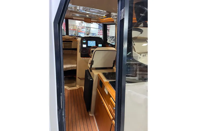 Slide: The Image of Interior view of 2017 Ranger Tugs R-23 boat, featuring helm and cabin area. - 17