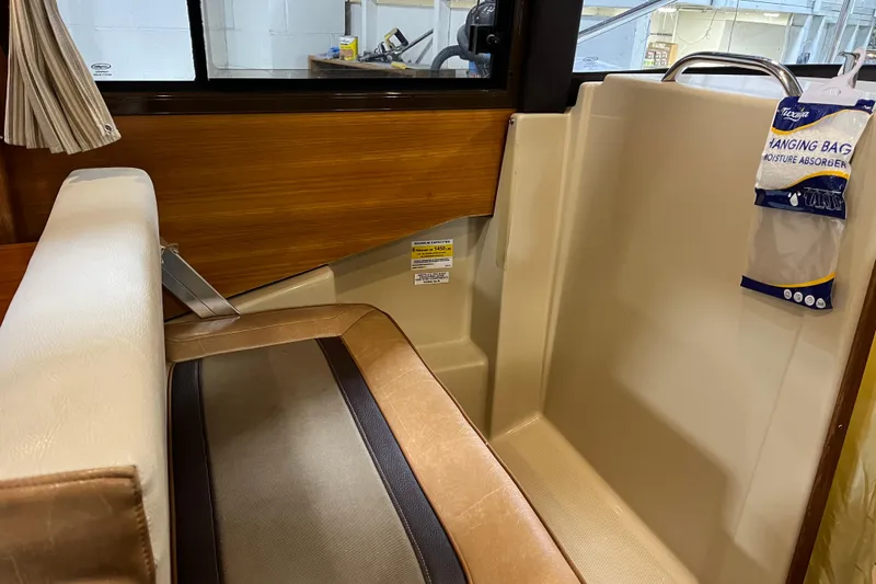 Slide: The Image of Interior of 2017 Ranger Tugs R-23 boat with seating and moisture absorber. - 18