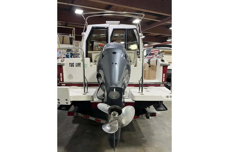 Slide: The Image of 2017 Ranger Tugs R-23 boat with outboard motor in a garage setting. - 4