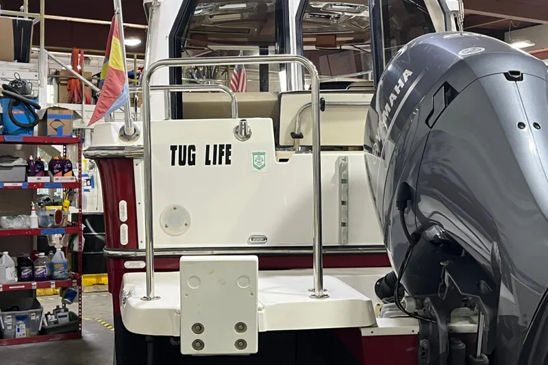 Slide: The Image of 2017 Ranger Tugs R-23 boat with "Tug Life" text and Yamaha outboard motor. - 5