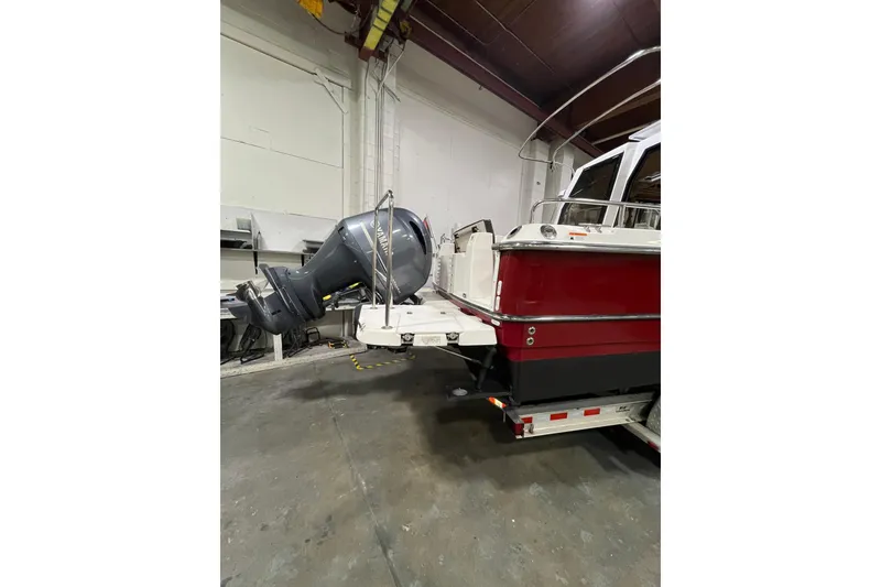 Slide: The Image of 2017 Ranger Tugs R-23 boat with outboard motor in a garage setting. - 8