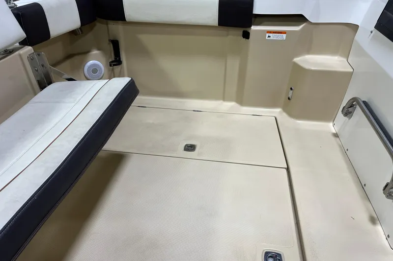 Slide: The Image of 2017 Ranger Tugs R-23 boat interior with beige flooring and cushioned seating. - 9