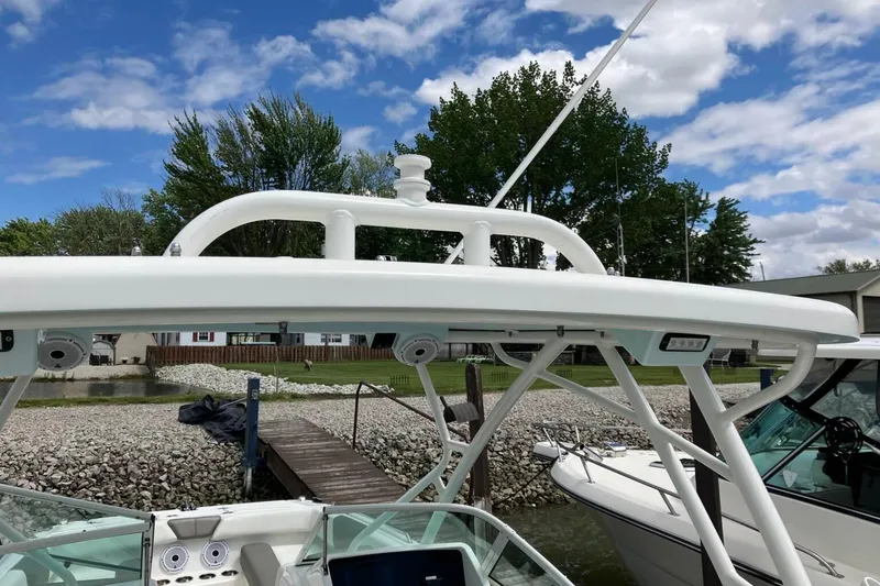 Slide: The Image of 2022 World Cat 230 DC boat docked, featuring a sleek white design and modern equipment. - 15