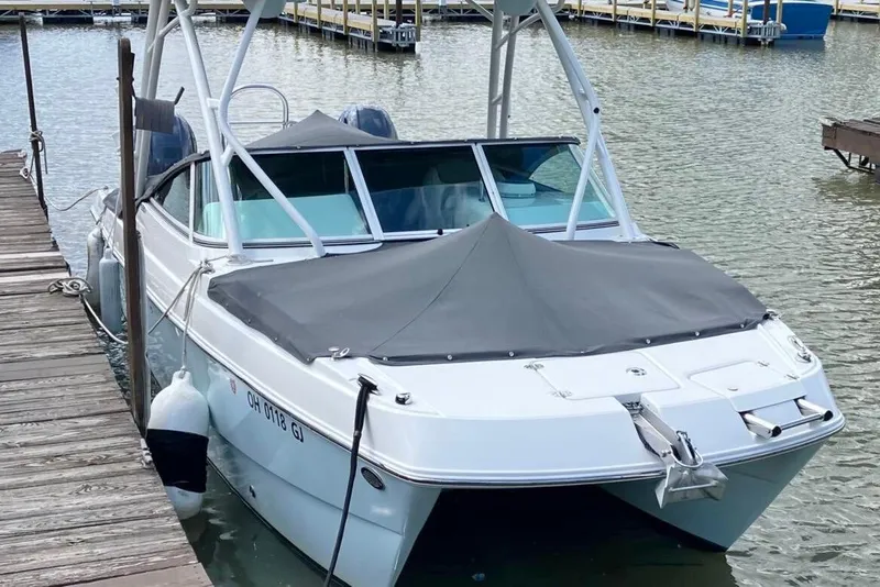 Slide: The Image of 2022 World Cat 230 DC boat docked at a marina, covered and ready for use. - 3