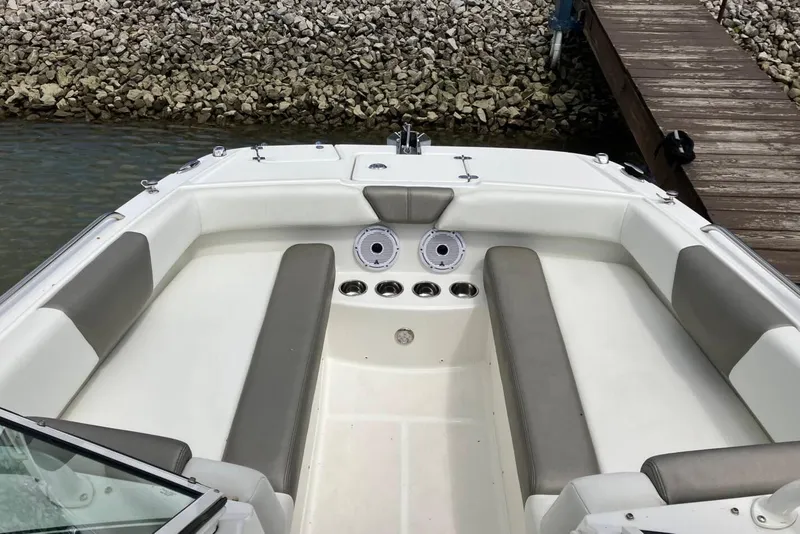 Slide: The Image of 2022 World Cat 230 DC boat interior with cushioned seating and cup holders. - 8