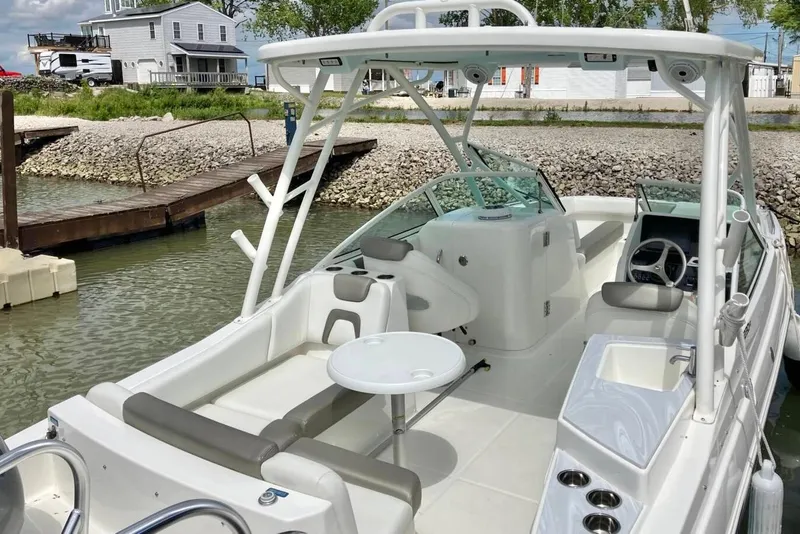 Slide: The Image of 2022 World Cat 230 DC boat docked, featuring spacious seating and modern amenities. - 9
