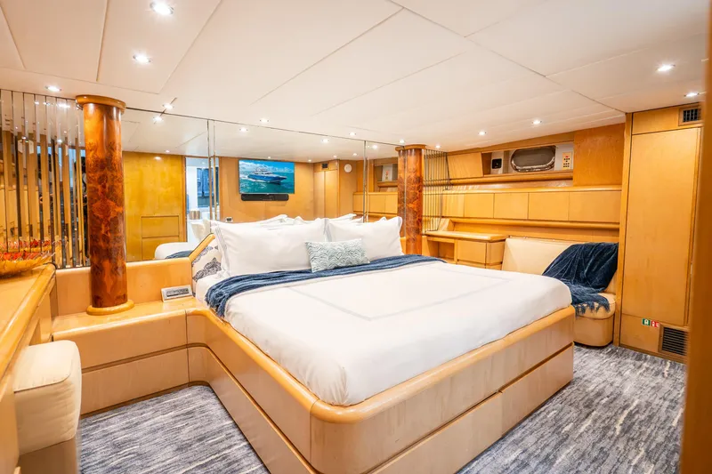 Slide: The Image of Luxurious Maiora Planning 1991 yacht bedroom with elegant wood finishes and plush bedding. - 11