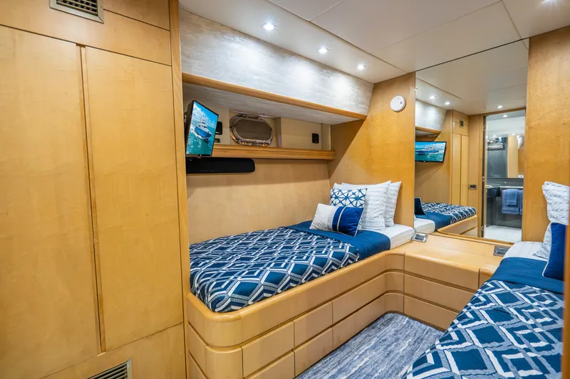 Slide: The Image of Luxurious 1991 Maiora Planning yacht cabin with twin beds, elegant wood finish, and modern decor. - 17