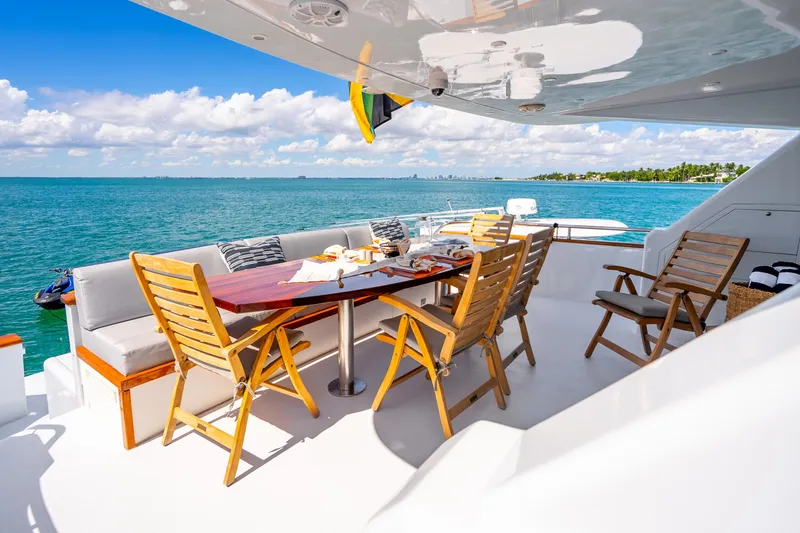 Slide: The Image of Luxurious 1991 Maiora Planning yacht deck with dining area overlooking serene ocean view. - 3