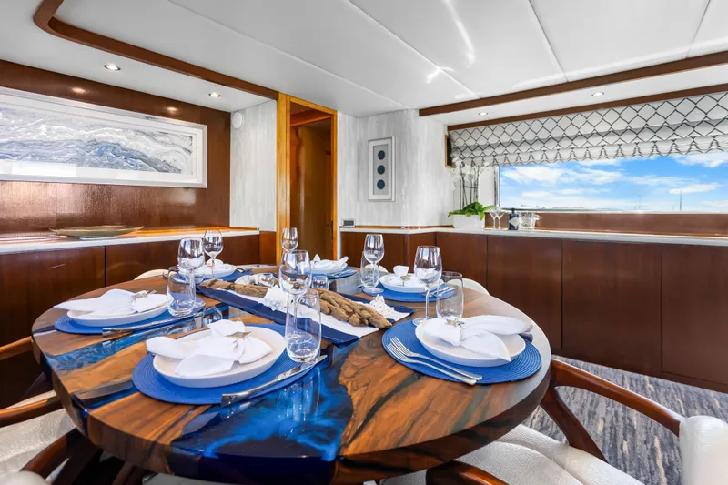 Slide: The Image of Luxurious dining area on a 1991 Maiora Planning yacht with elegant table setting. - 7