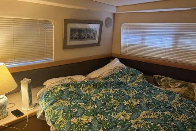 Slide: The Image of Cozy bedroom in 1996 Carver 355 Aft Cabin Motor Yacht with tropical bedding. - 14