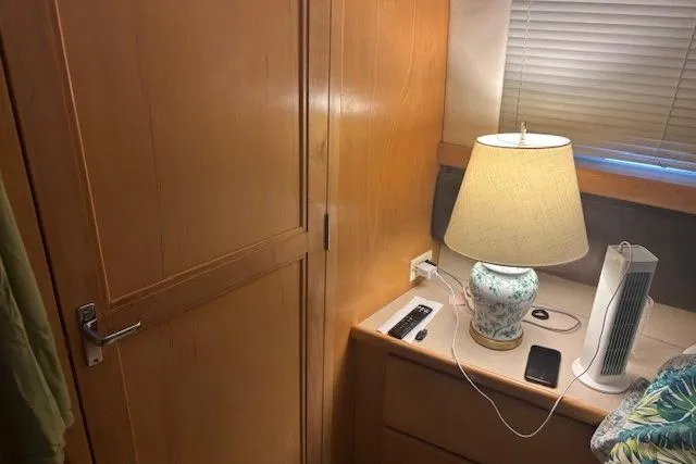 Slide: The Image of 1996 Carver 355 Aft Cabin Motor Yacht interior with lamp, cabinet, and blinds. - 15