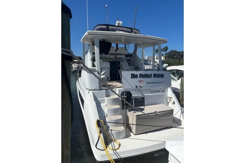 Slide: The Image of 1996 Carver 355 Aft Cabin Motor Yacht docked, featuring spacious deck and elegant design. - 2