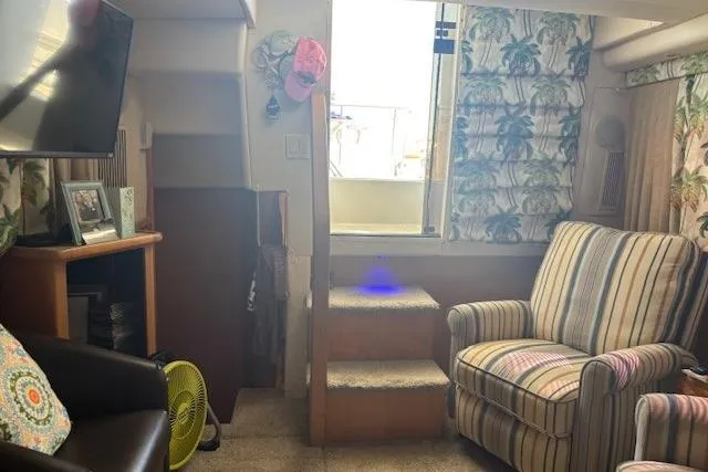 Slide: The Image of Interior of 1996 Carver 355 Aft Cabin Motor Yacht with cozy seating and decor. - 9