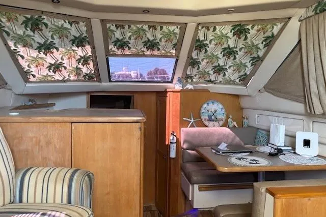 Slide: The Image of Interior of 1996 Carver 355 Aft Cabin Motor Yacht with tropical decor and seating area. - 11