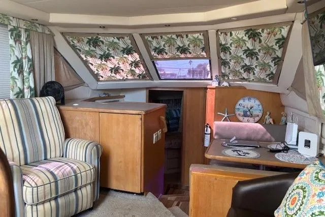 Slide: The Image of Interior of 1996 Carver 355 Aft Cabin Motor Yacht with tropical decor and striped armchair. - 16