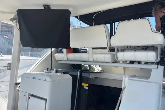 Slide: The Image of 1996 Carver 355 Aft Cabin Motor Yacht interior with white seating and storage compartments. - 17