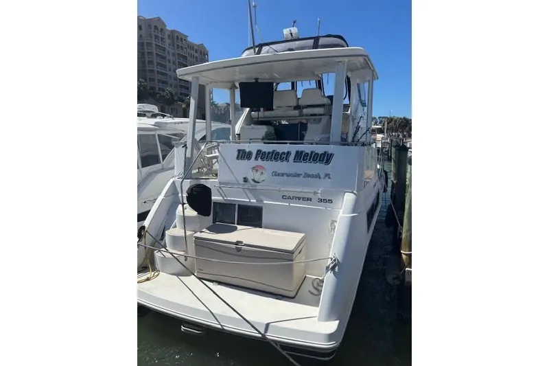 Slide: The Image of 1996 Carver 355 Aft Cabin Motor Yacht docked, rear view with name "The Perfect Melody." - 3