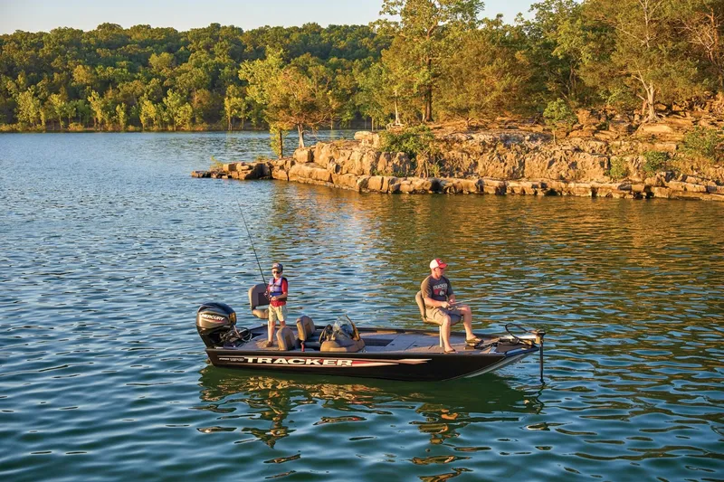 Slide: The Image of Two people fishing on a 2026 Tracker Pro 170 boat in a scenic lake. - 10