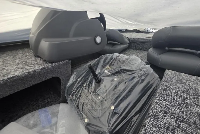 Slide: The Image of Interior of 2026 Tracker Pro 170 boat with covered controls and seating. - 4