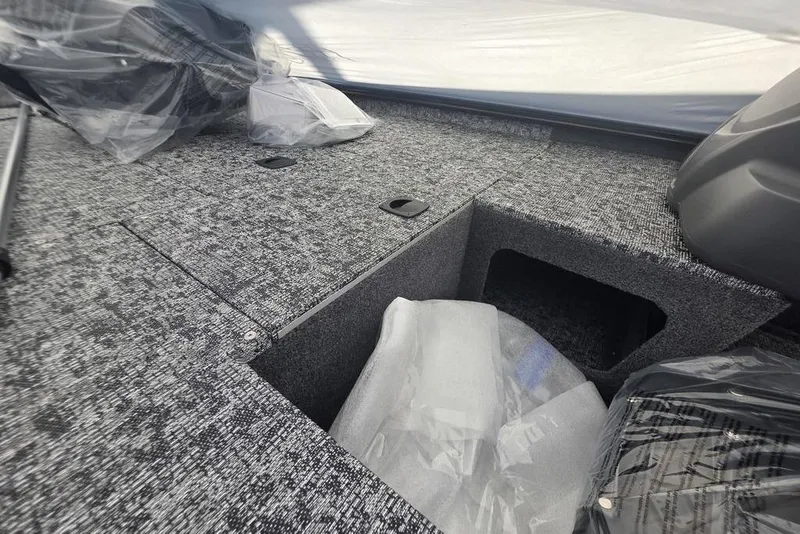 Slide: The Image of 2026 Tracker Pro 170 boat interior with storage compartments and protective coverings. - 5